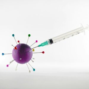 white and green syringe on white surface