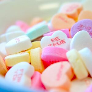 assorted hear-shape candies on white bowl